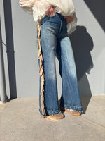 Jeans con frange laterali