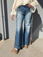 Jeans con frange laterali